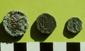 Photo of 3 hellenistic coins on green background. The left one depicts Demetrios Nikator.